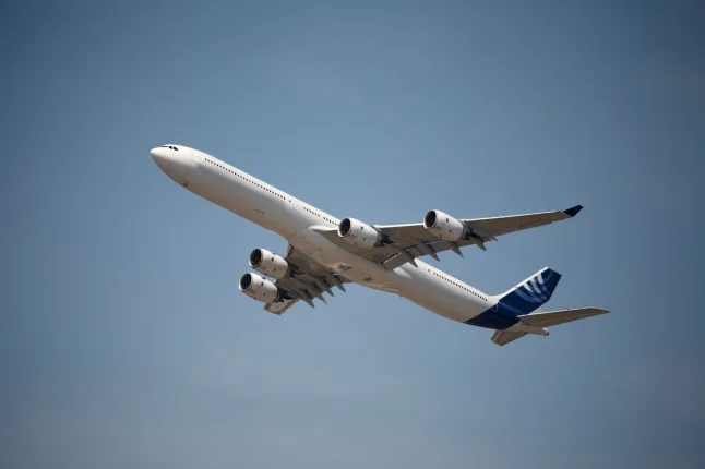 Aviation safety concept featuring a commercial airplane in flight against a clear sky, emphasizing the importance of safety for airlines and regulators. Credit: Getty Images/Dealzflight